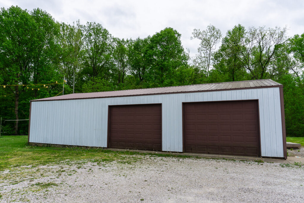 Storage shed at McCormick's Creek Church surrounded by greenery.