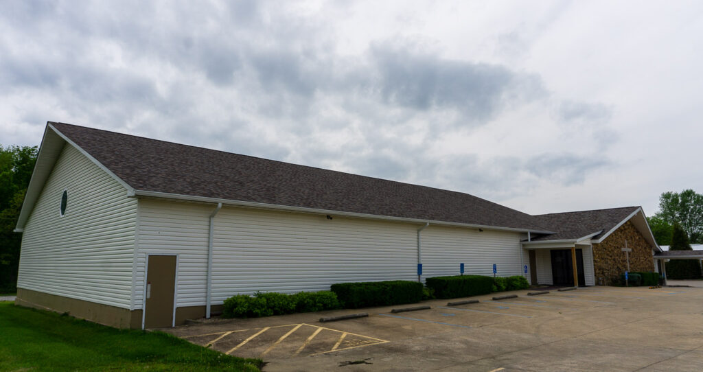 Side view of McCormick's Creek Church showing the building and parking lot.