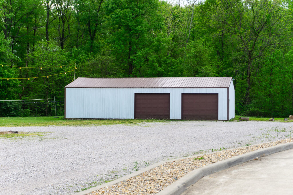 Second storage shed at McCormick's Creek Church with a backdrop of trees.